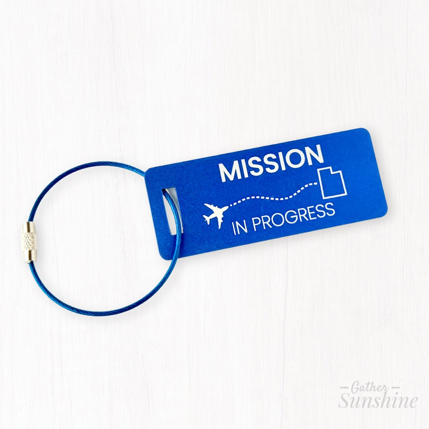 Blue “Mission in Progress” small luggage tag with airplane flight path to outlined Utah. Personalized LDS missionary travel gift by GatherSunshine.