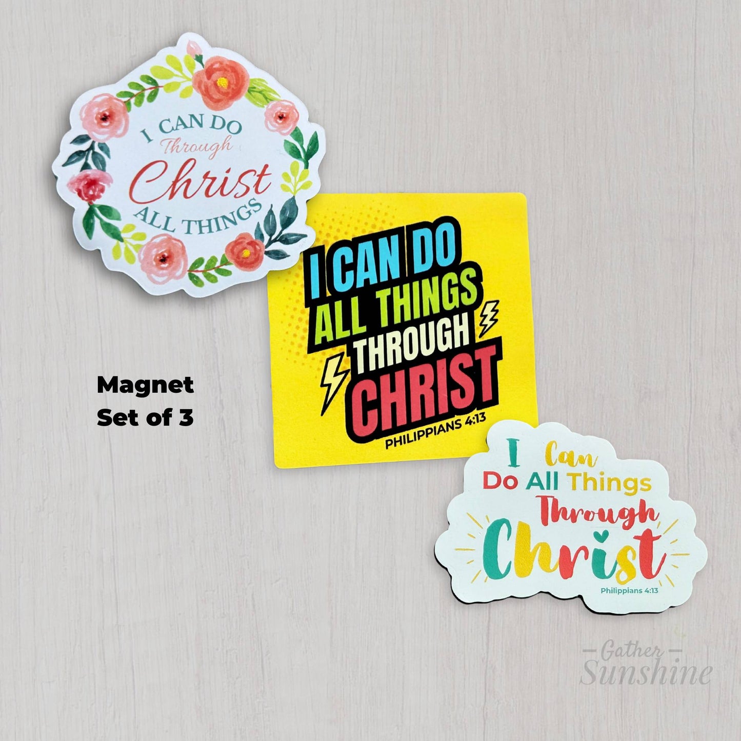 Set of three ‘I Can Do All Things Through Christ’ designs – floral circular pink and green, multicolor script with sunburst, and bold superhero comic style – 3 inch Christian magnets by Gather Sunshine.