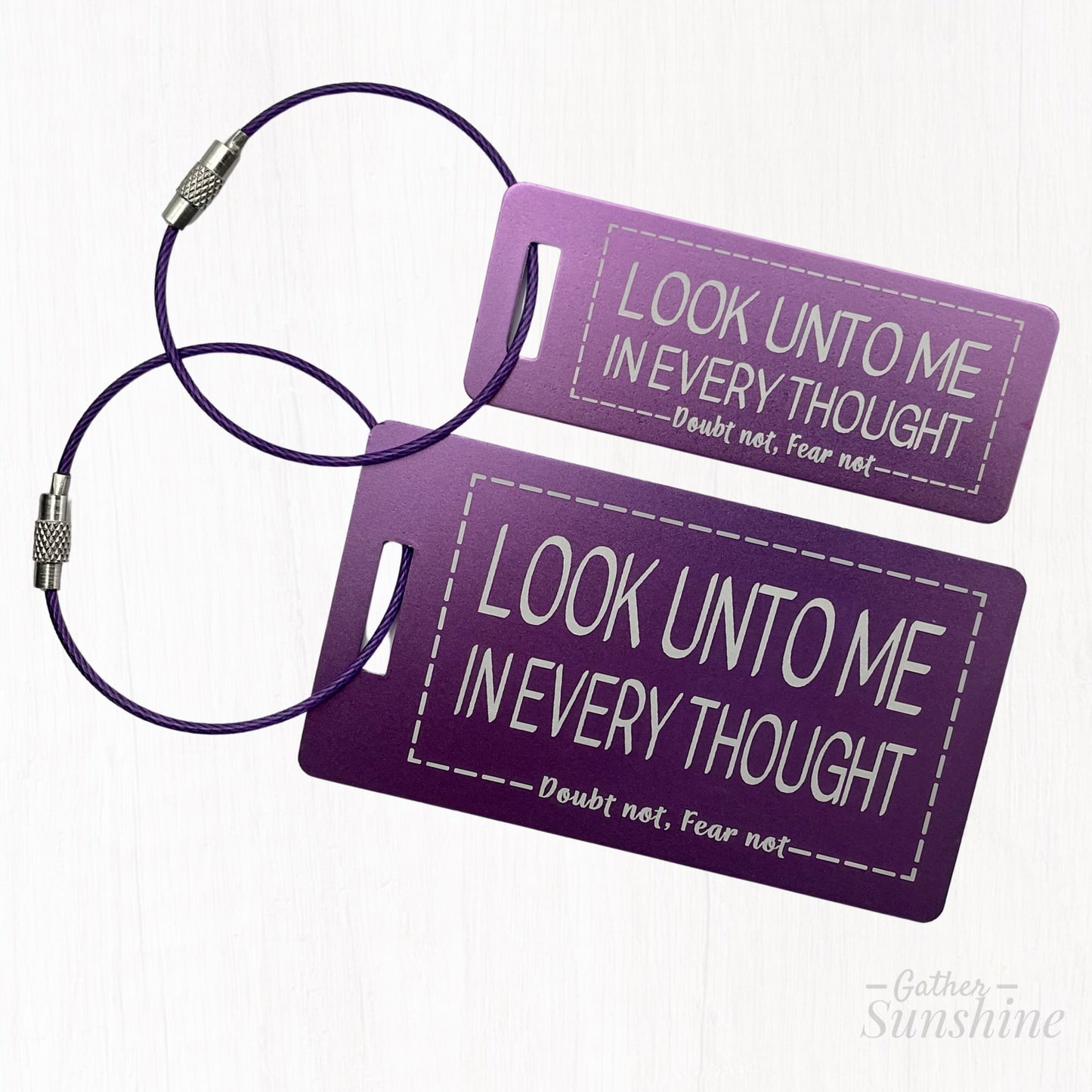 Small (3"x1") and large (3.5"x2") purple luggage tags with motivational text "Look Unto Me In Every Thought, Doubt Not, Fear Not" by Gather Sunshine.