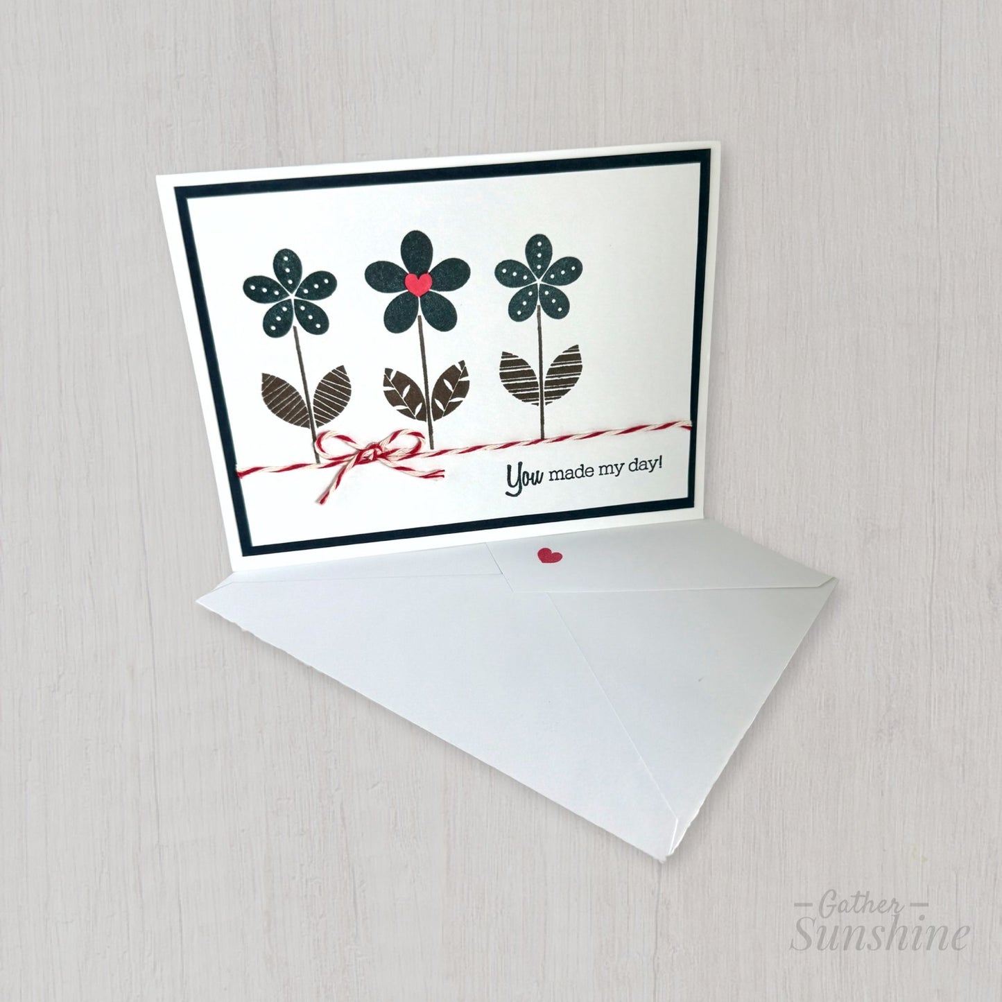 Hand-stamped navy blue flower card with red heart, bow, and “You made my day” phrase, paired with envelope by Gather Sunshine