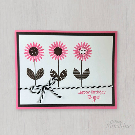 Hand-stamped pink and smokey black floral birthday greeting card standing upright, boutique design by Gather Sunshine