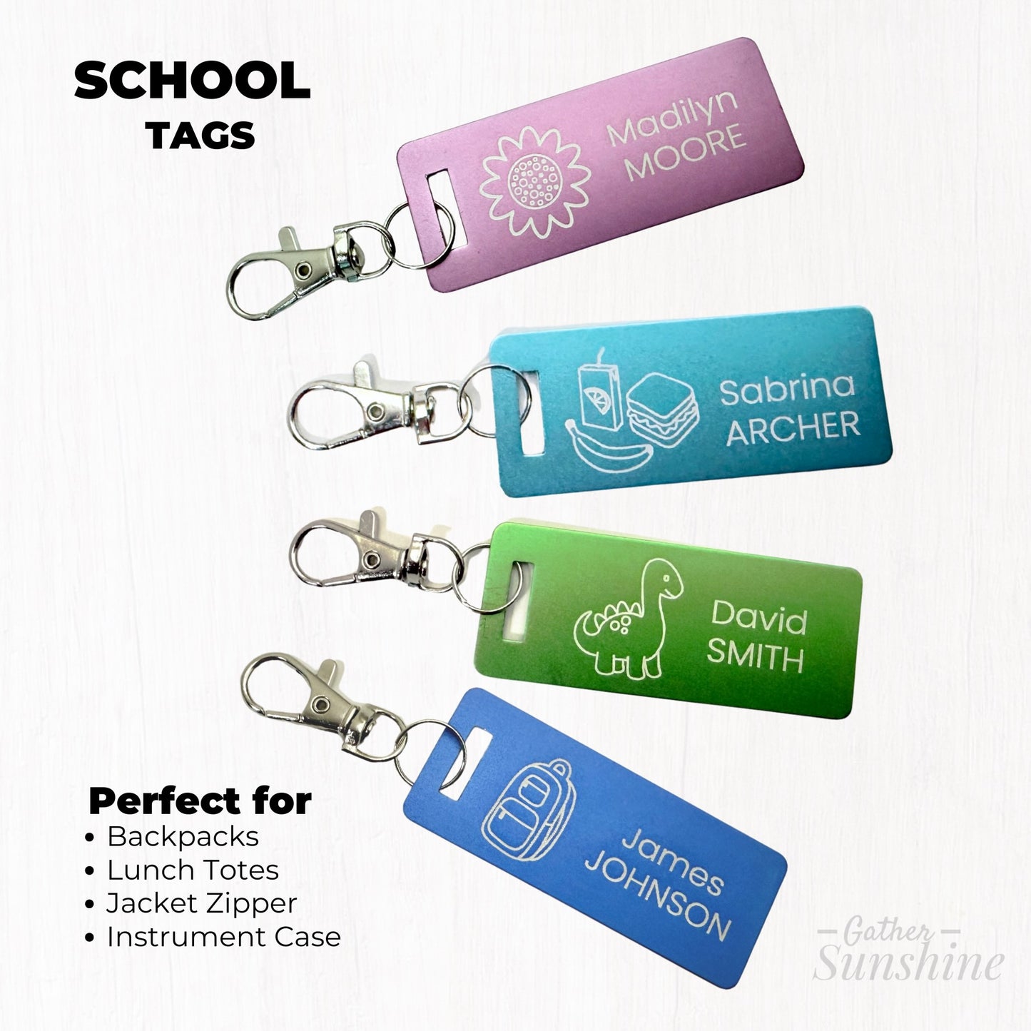 Set of four colorful 1x3 inch kids luggage tags, each with a lobster clasp: a purple flower tag, blue backpack tag, green dinosaur tag, and teal lunch tag — all personalized with names. Perfect for backpacks, lunch boxes, Jacket zipper , and instrument cases. GatherSunshine.