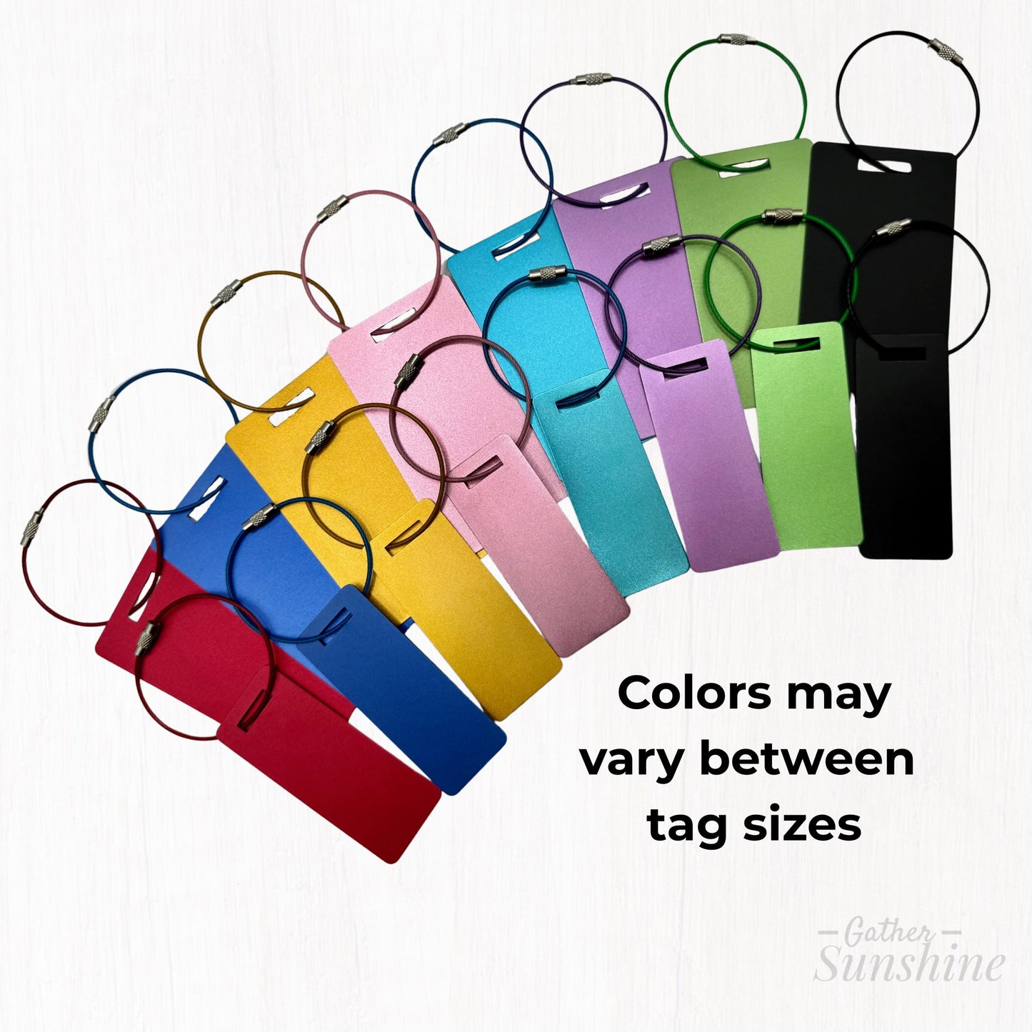 Small and large luggage tags shown with stainless steel loops attached in 8 colors. Approx. sizes: small 3x1 inches, large 3.5x2 inches. Slight tone variations may be visible between sizes