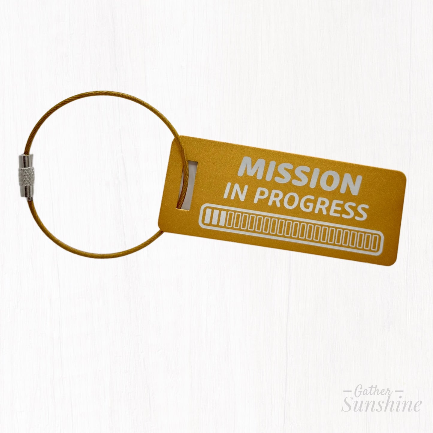 Small yellow 3x1 inch “Mission in Progress” tag featuring an engraved progress bar design. Personalized LDS missionary gift by GatherSunshine.