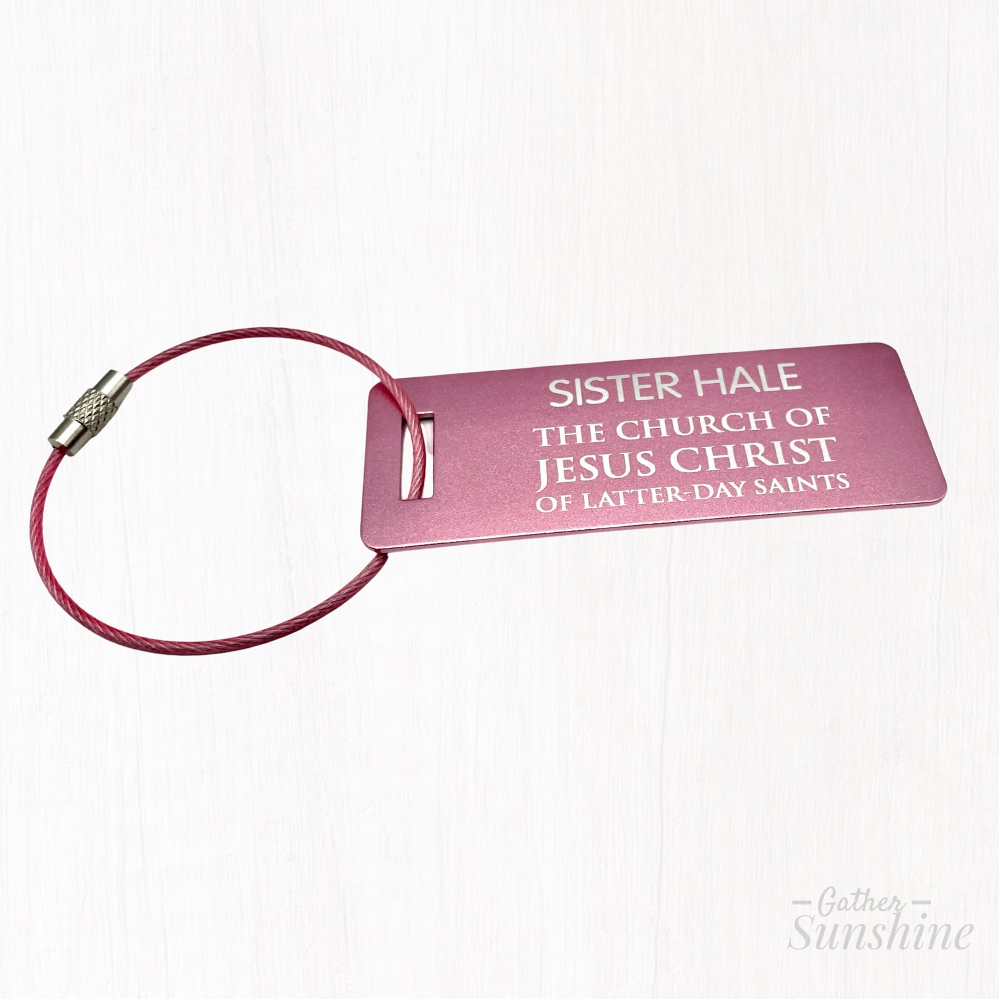 Pink LDS-style missionary small luggage tag in English, shown at a different angle on white background. Size: 3x1 inch. A bold, colorful alternative by GatherSunshine.