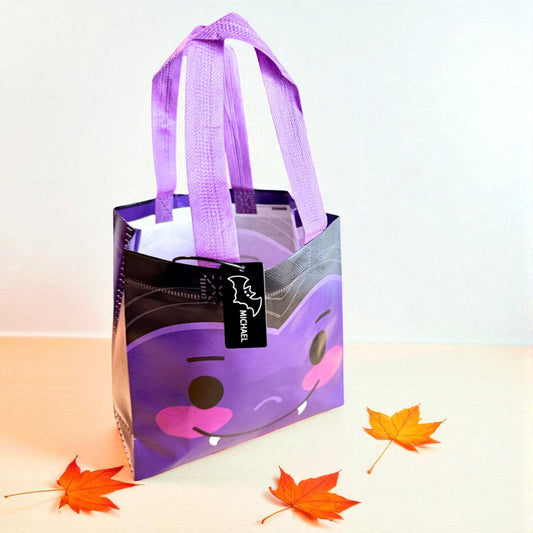 Purple bat Halloween trick-or-treat bag with personalized engraved tag by Gather Sunshine.