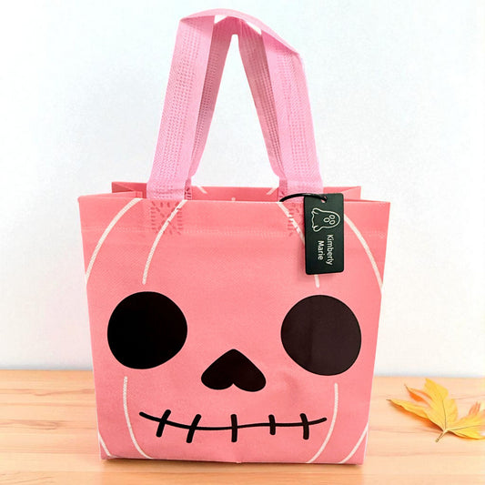 Pink skull Halloween trick-or-treat bag with personalized engraved Halloween tag by Gather Sunshine.