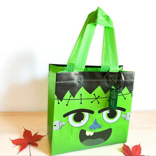 Green Frankenstein trick-or-treat bag with personalized engraved Halloween tag by Gather Sunshine.