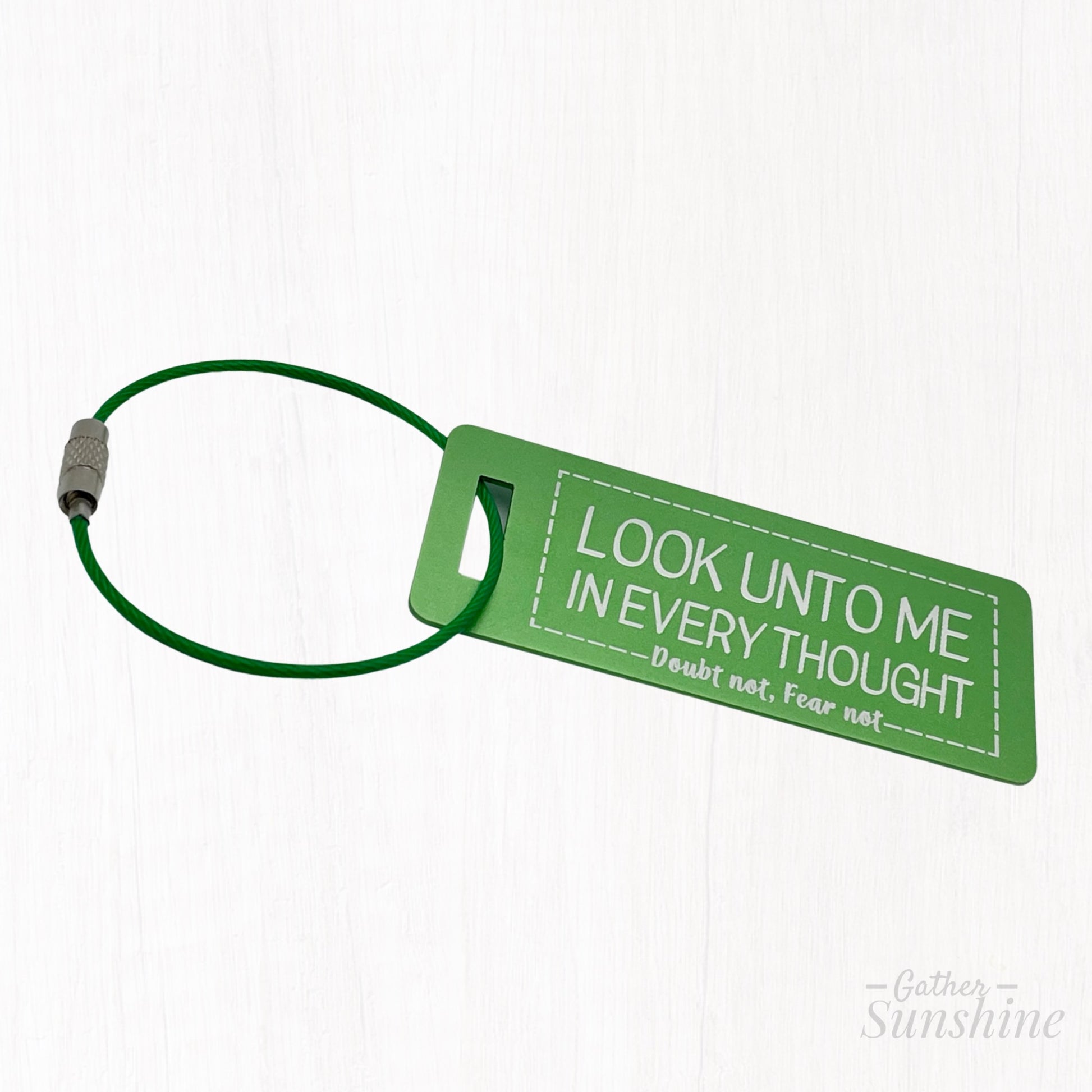 Small (3"x1") green luggage tag with motivational text "Look Unto Me In Every Thought, Doubt Not, Fear Not" by Gather Sunshine.