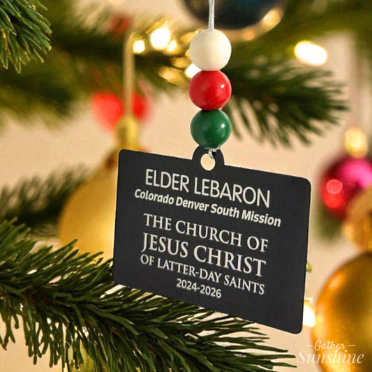 LDS Missionary Tag Christmas ornament  hanging on a decorated tree.  Custome engraved by Gather Sunshine.