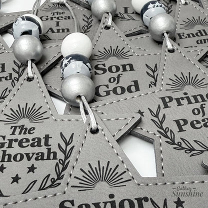 Close up of gray names of christ ornaments by Gather Sunshine.