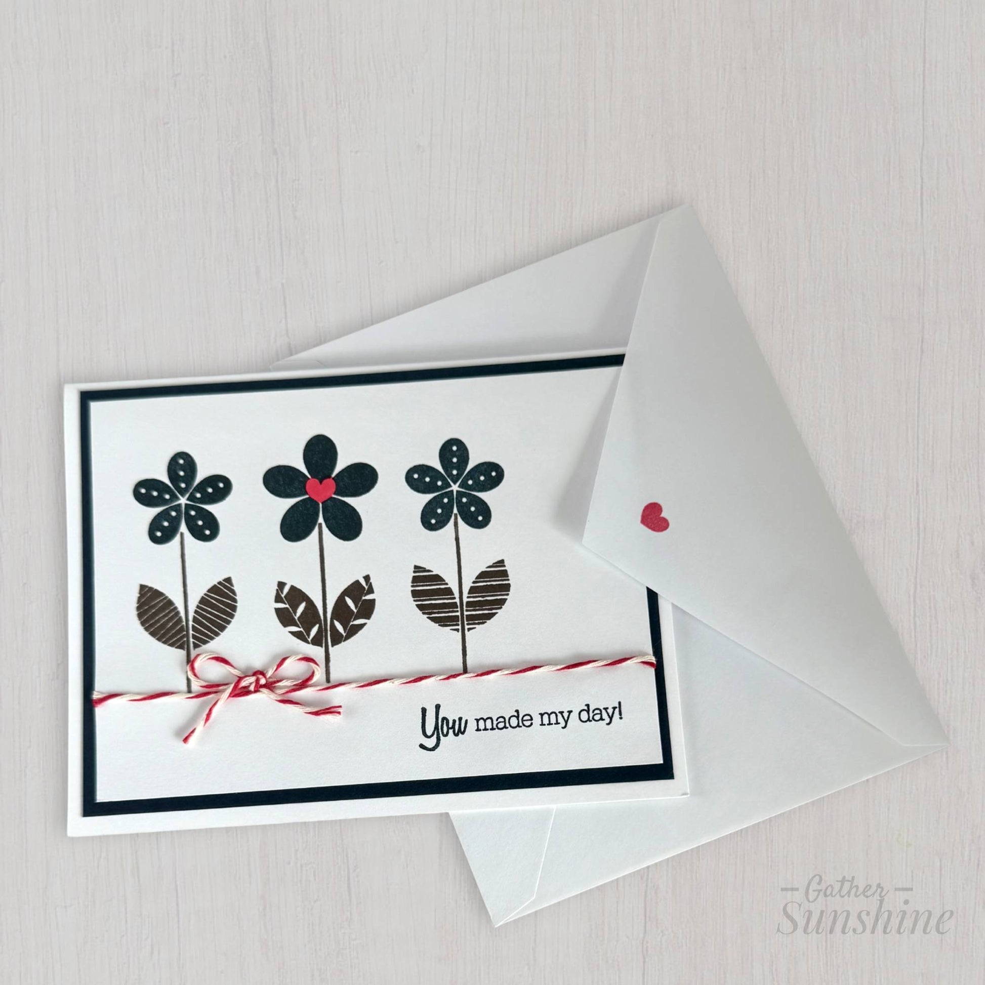 Hand-stamped navy blue flower card with red heart, bow, and “You made my day” phrase, paired with envelope by Gather Sunshine