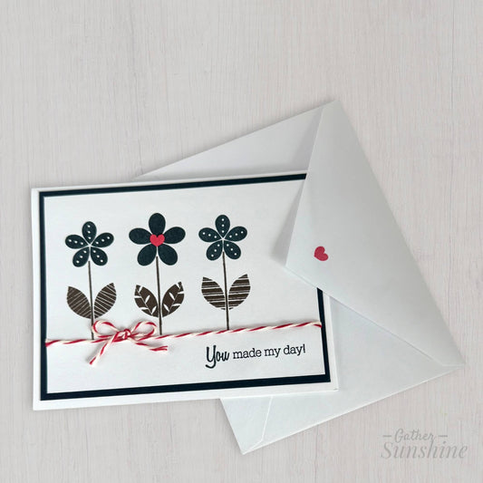 Hand-stamped navy blue flower card with red heart, bow, and “You made my day” phrase, paired with envelope by Gather Sunshine