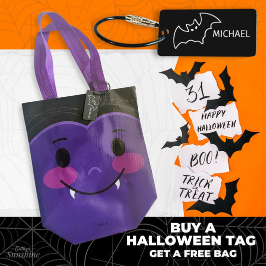 Halloween-themed purple bag with a smiley bat face and a Bat with name tag by Gather Sunshine.