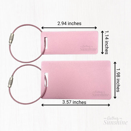 Side-by-side size comparison of large and small pink tags. Large tag measures approximately 3.5 x 2 inches and small tag is about 3 x 1 inch. Measurements are shown next to each tag - personalized engraving by Gather Sunshine. 