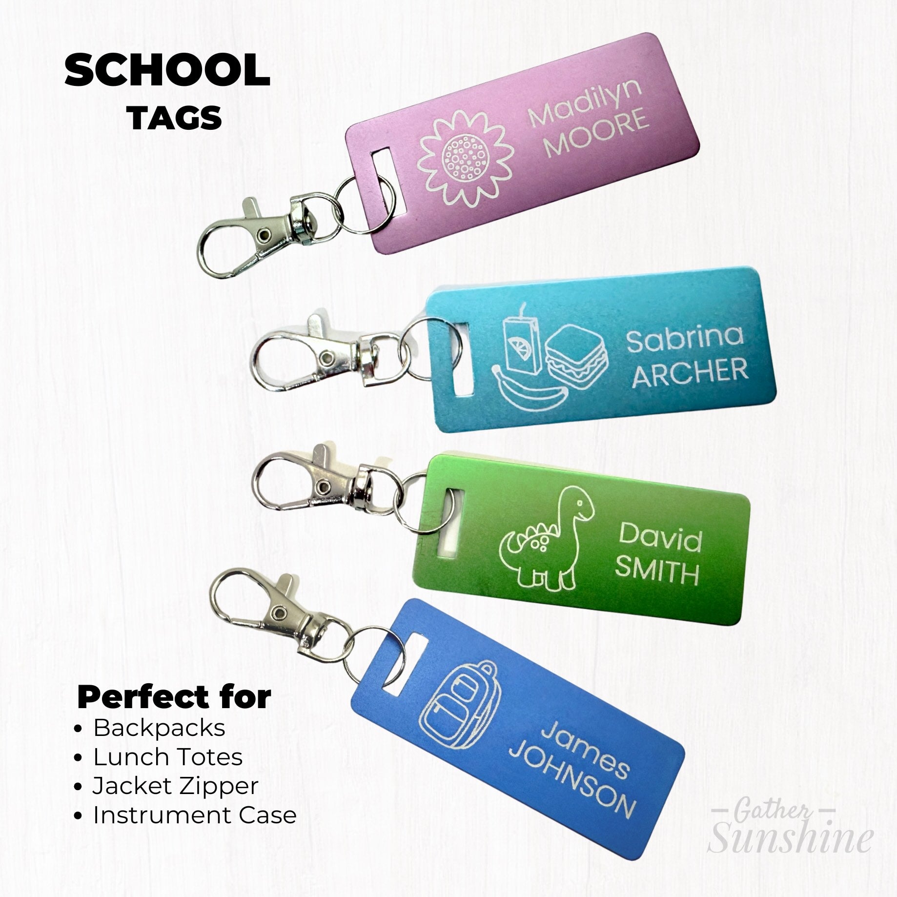 Set of four colorful 1x3 inch kids luggage tags, each with a lobster clasp: a purple flower tag, blue backpack tag, green dinosaur tag, and teal lunch tag — all personalized with names.  Perfect for backpacks, lunch boxes, Jacket zipper , and instrument cases. GatherSunshine.