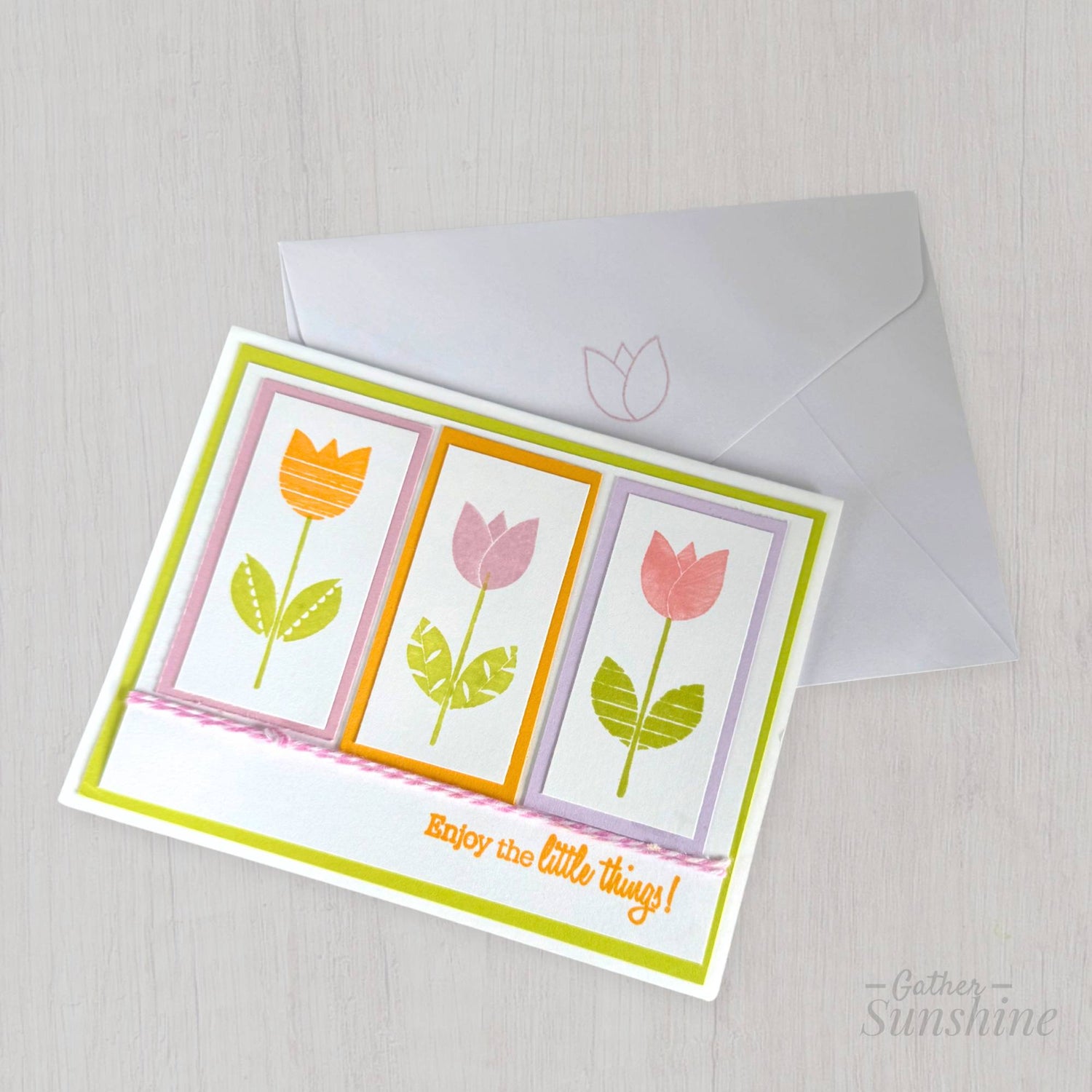 Handmade tulip greeting card with stamped flowers, string bow, and “Enjoy the little things” phrase, paired with envelope by Gather Sunshine